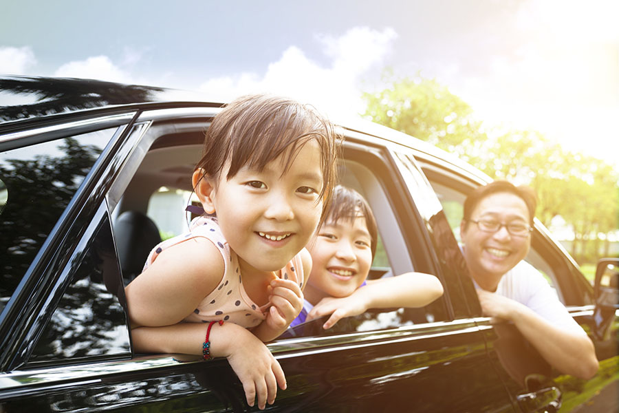 Personal Insurance - Happy Family Sitting In Car Looking Out Window